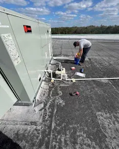 Integrate HVAC with Smart Home Systems 3 Technician installing a smart thermostat, illustrating the professional installation process for HVAC systems